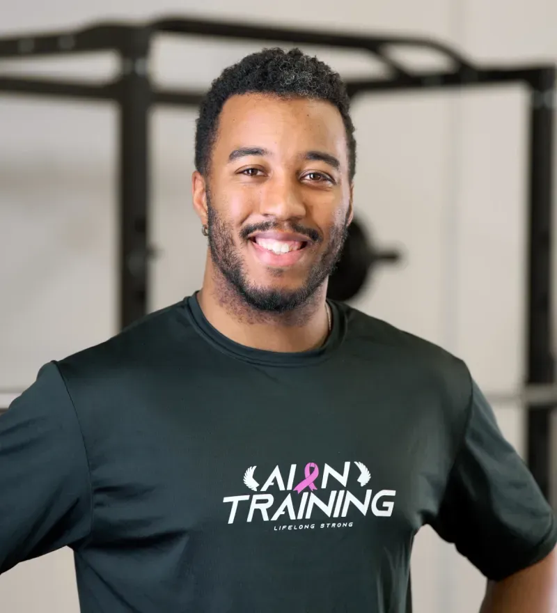 Marcus McDuffie, founder of Aion Personal Training, smiling in an Aion shirt.